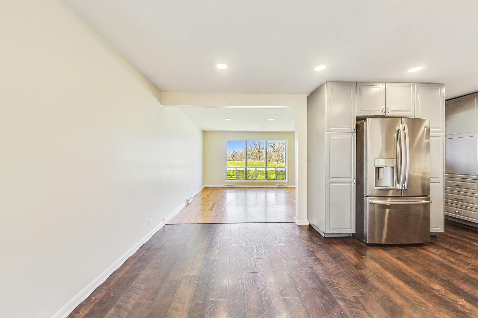 1235 Sunset Ridge Road Northbrook, IL 60062 - Photo 8 of 47 a view of a refrigerator in kitchen and wooden floor