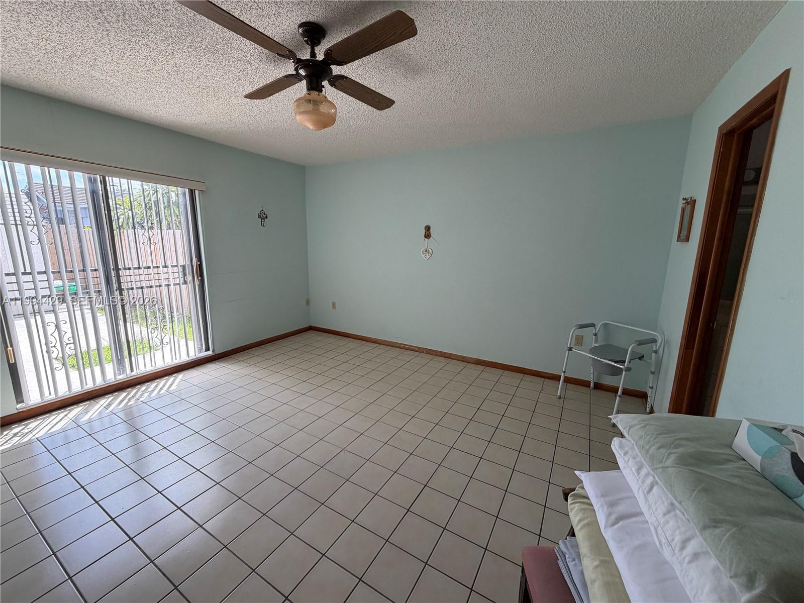 13470 Southwest 27th Street Miami, FL 33175 - Photo 8 of 11 a view of empty room with wooden floor