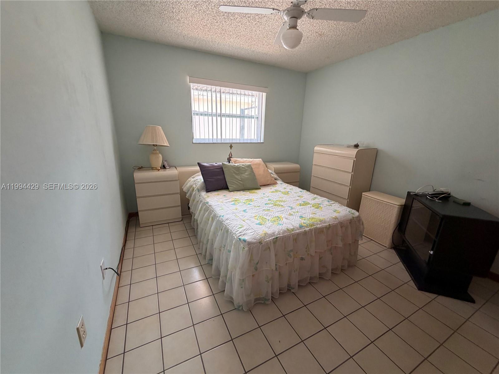 13470 Southwest 27th Street Miami, FL 33175 - Photo 9 of 11 a bedroom with a bed and painting on the wall