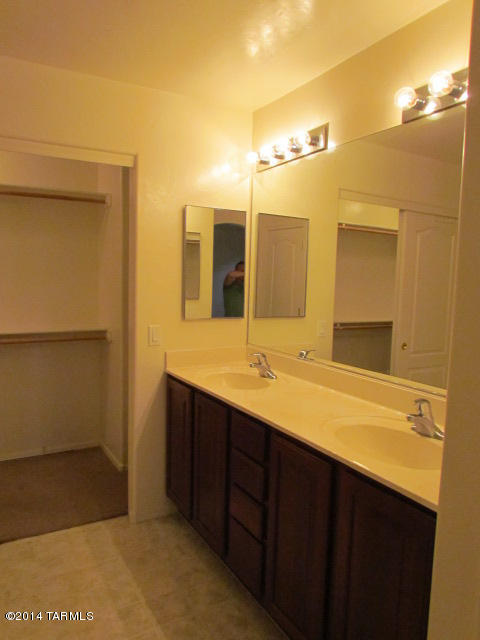 669 West Ash Ridge Drive Green Valley, AZ 85614 - Photo 8 of 17 a bathroom with a double vanity sink and a mirror