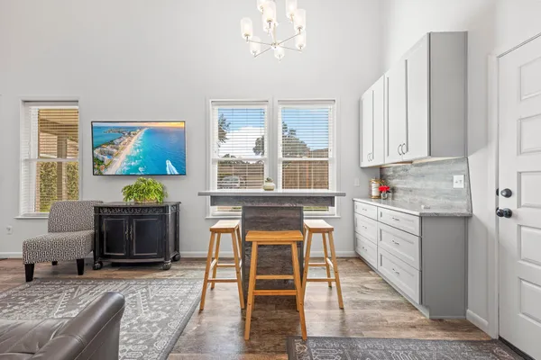 a kitchen with stainless steel appliances granite countertop a stove a sink and a microwave