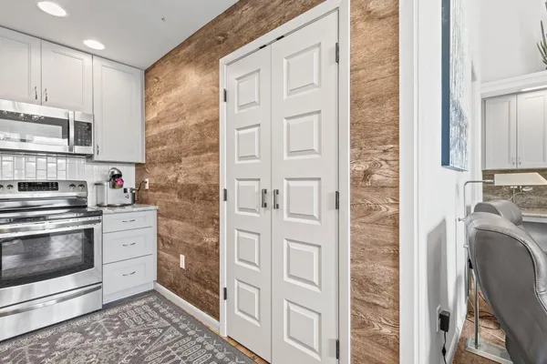 a kitchen with stainless steel appliances granite countertop a stove a sink and a refrigerator