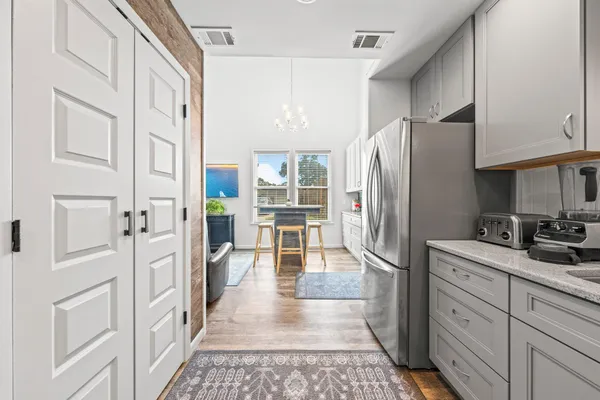 a kitchen with stainless steel appliances granite countertop a refrigerator and a stove top oven
