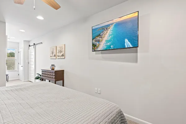 a bedroom with a bed and a painting on the wall