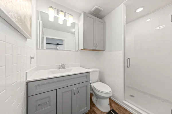 a bathroom with a toilet a sink and mirror