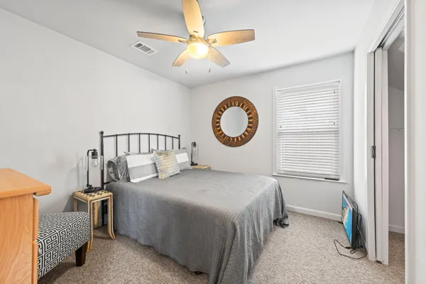 a bedroom with a bed and a chandelier