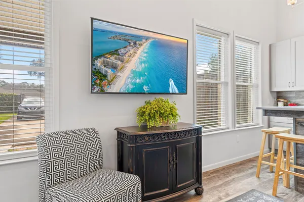 a living room with a rug and a window