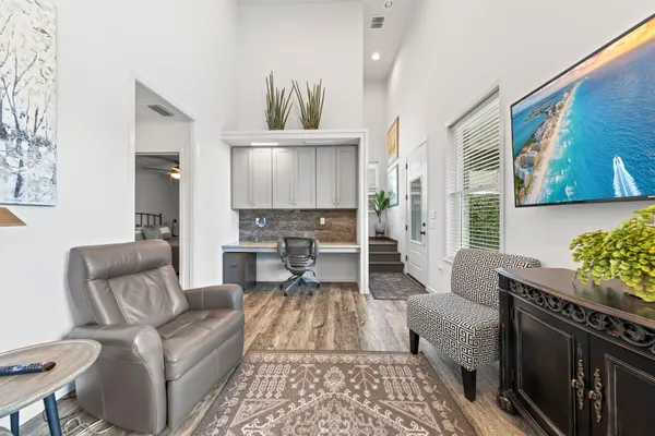 a living room with furniture and wooden floor