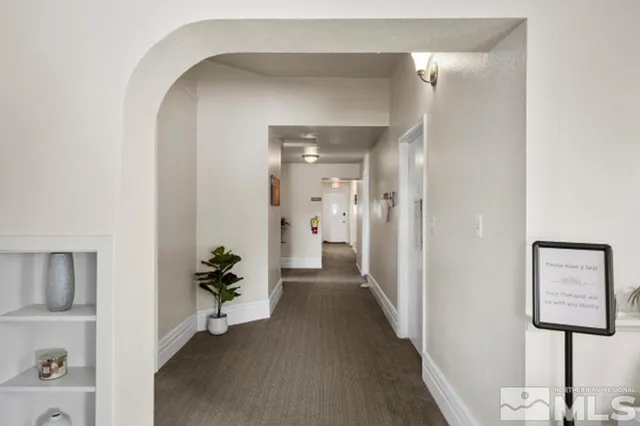 a view of a hallway with paintings on the wall