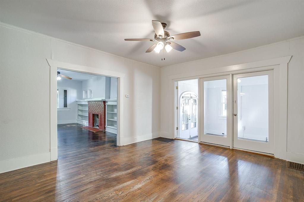 2312 Mistletoe Avenue Fort Worth, TX 76110 - Photo 11 of 40 a view of an empty room with wooden floor and a window
