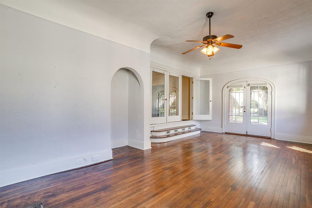 2312 Mistletoe Avenue Fort Worth, TX 76110 - Photo 15 of 40 a view of an empty room with a window and wooden floor