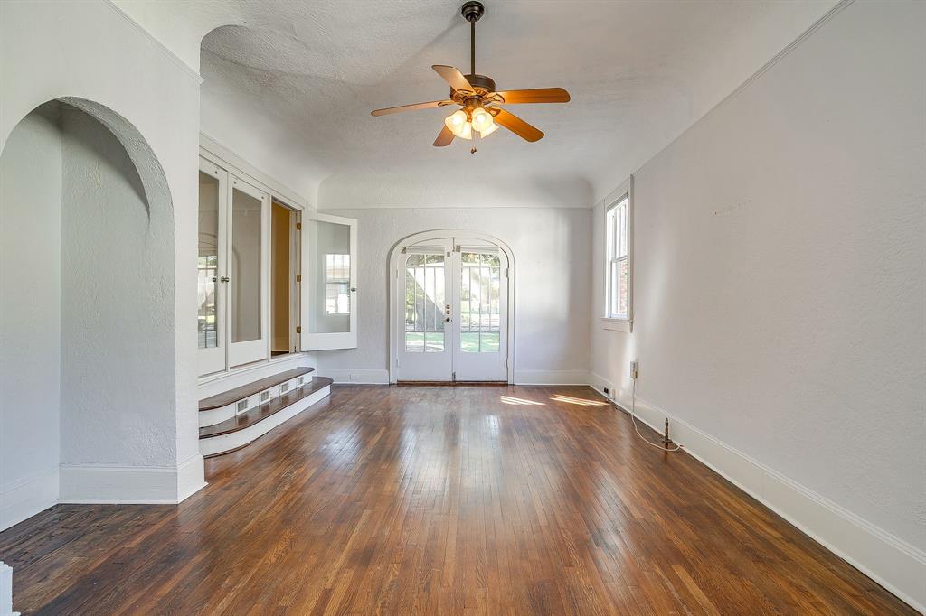 2312 Mistletoe Avenue Fort Worth, TX 76110 - Photo 16 of 40 a view of an empty room with a window and wooden floor
