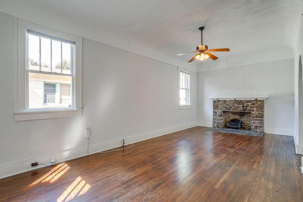2312 Mistletoe Avenue Fort Worth, TX 76110 - Photo 18 of 40 wooden floor in an empty room with a window
