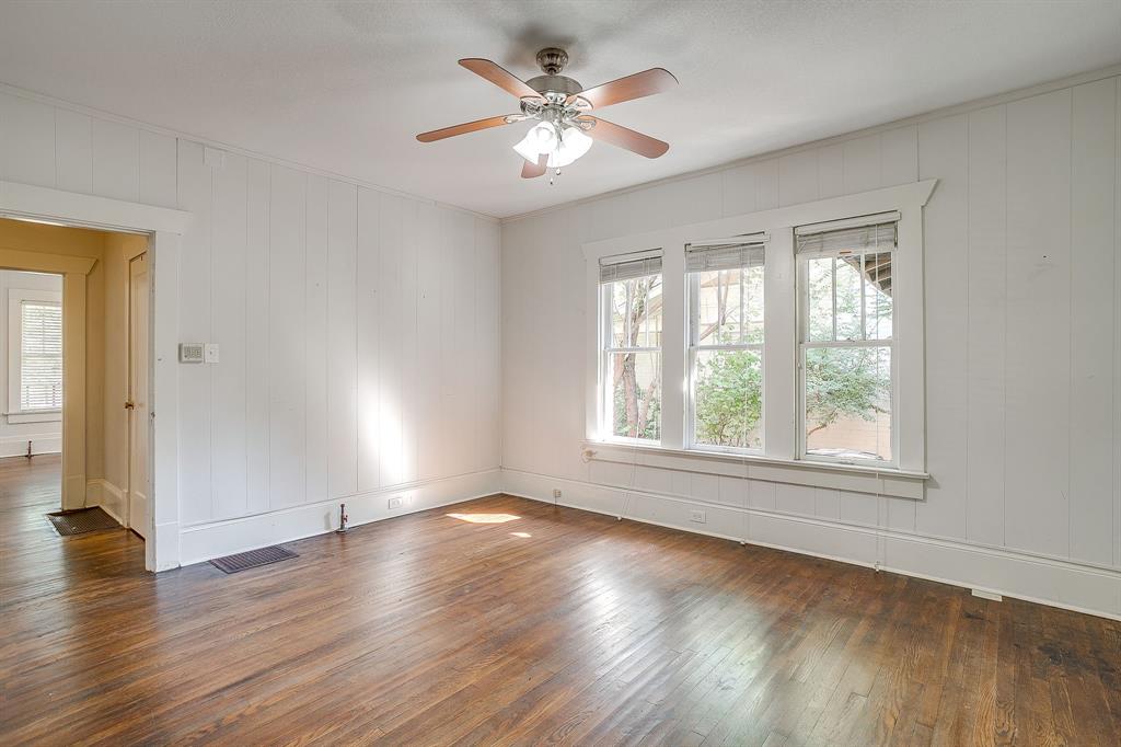 2312 Mistletoe Avenue Fort Worth, TX 76110 - Photo 20 of 40 an empty room with wooden floor and windows
