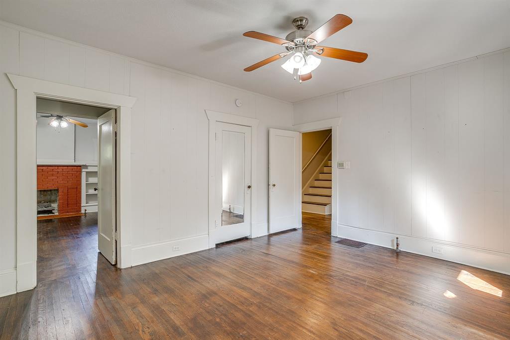 2312 Mistletoe Avenue Fort Worth, TX 76110 - Photo 21 of 40 a view of a livingroom with wooden floor and a ceiling fan