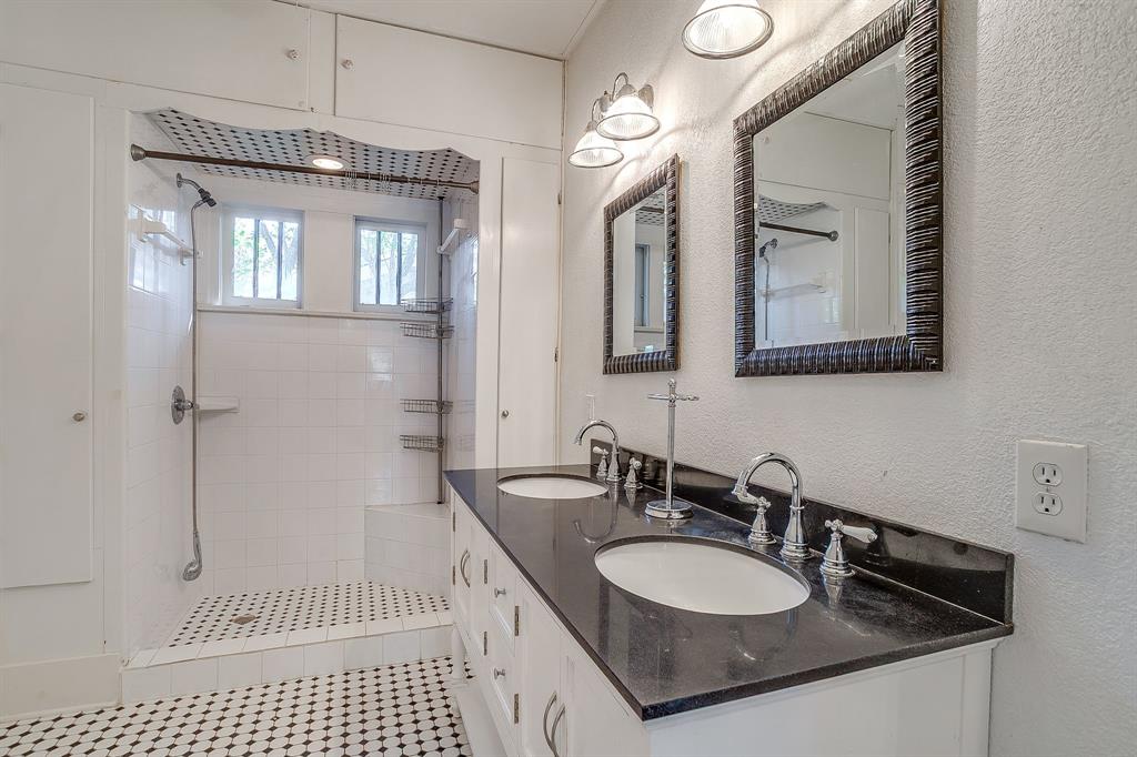 2312 Mistletoe Avenue Fort Worth, TX 76110 - Photo 23 of 40 a bathroom with a sink a vanity and a mirror