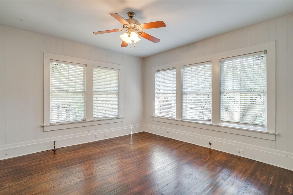 2312 Mistletoe Avenue Fort Worth, TX 76110 - Photo 24 of 40 an empty room with wooden floor and windows