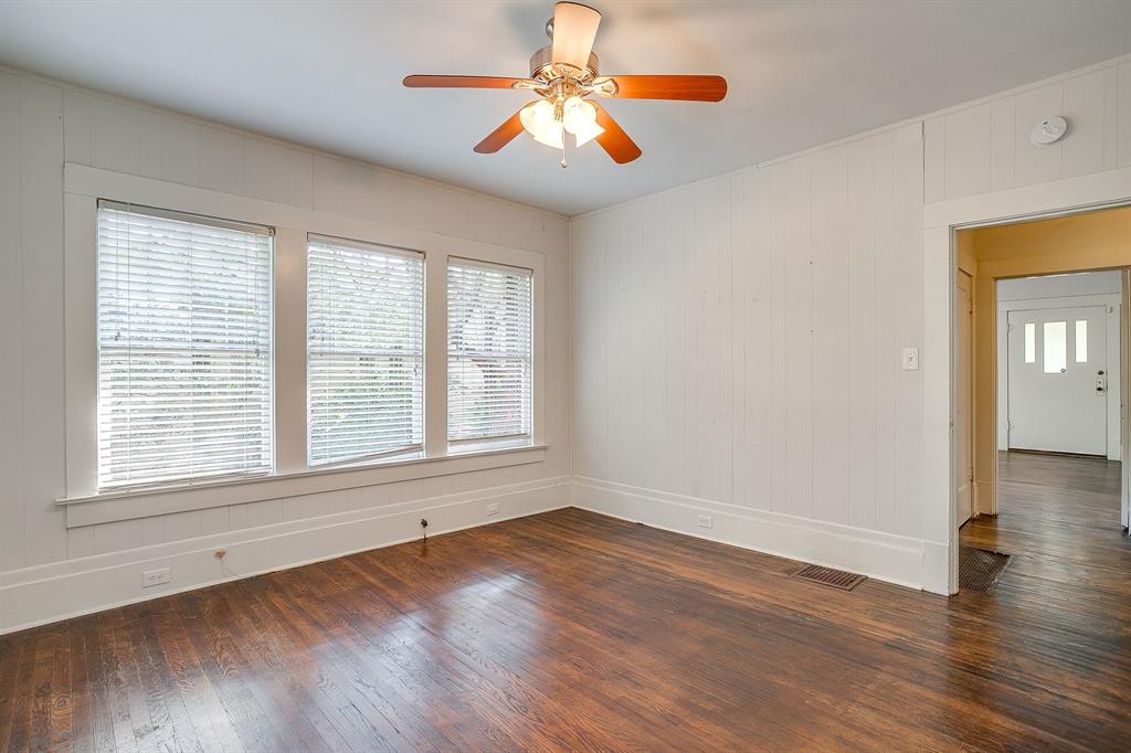 2312 Mistletoe Avenue Fort Worth, TX 76110 - Photo 25 of 40 a view of an empty room with window and wooden floor
