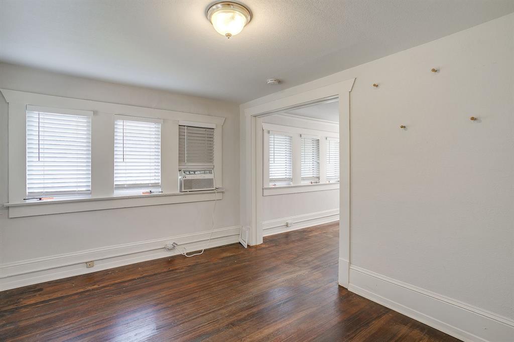 2312 Mistletoe Avenue Fort Worth, TX 76110 - Photo 27 of 40 an empty room with wooden floor and windows