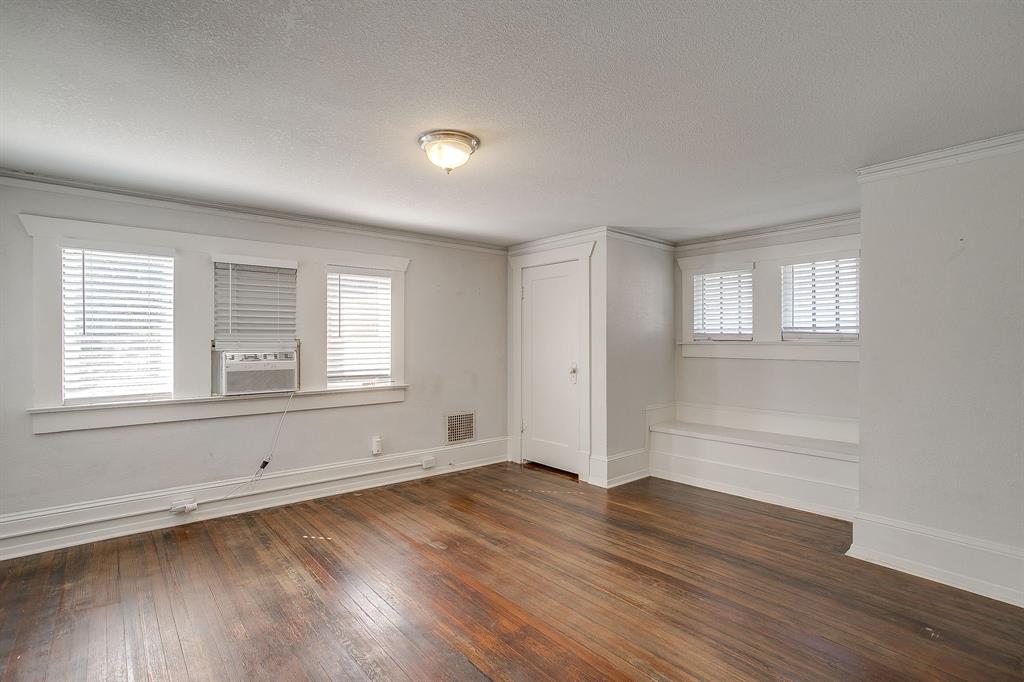 2312 Mistletoe Avenue Fort Worth, TX 76110 - Photo 29 of 40 an empty room with wooden floor and windows