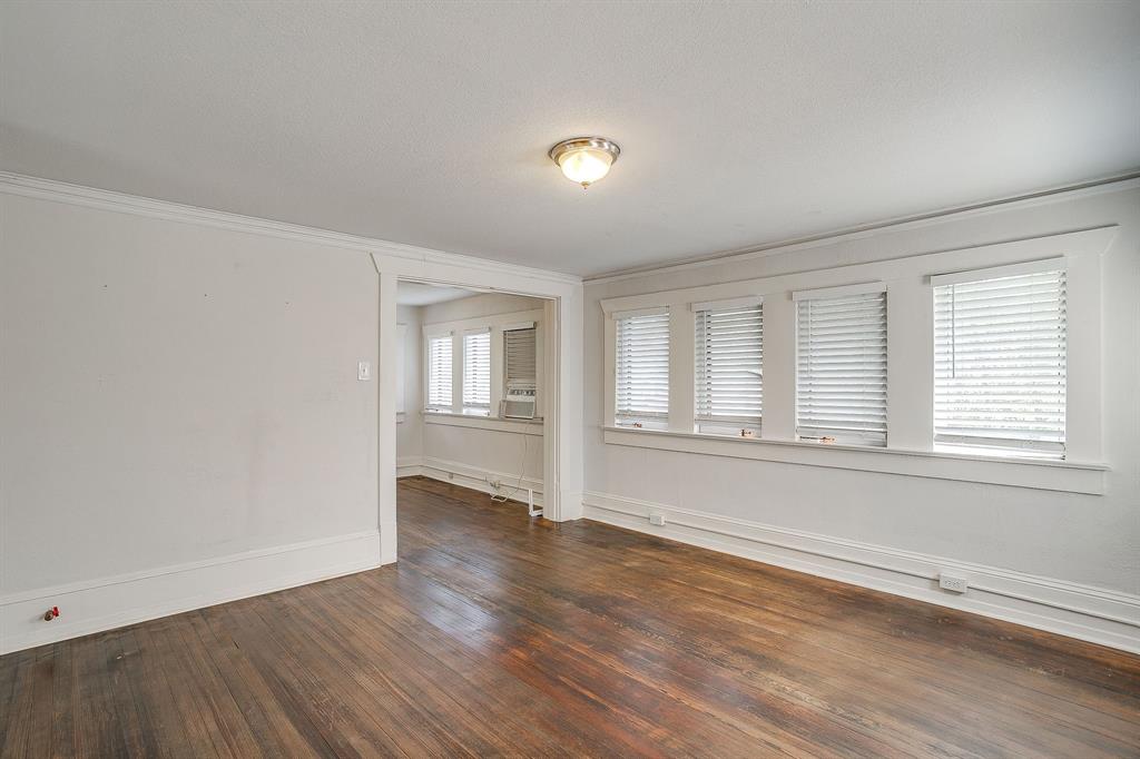 2312 Mistletoe Avenue Fort Worth, TX 76110 - Photo 31 of 40 an empty room with wooden floor and windows
