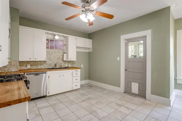 a kitchen with a sink cabinets and window