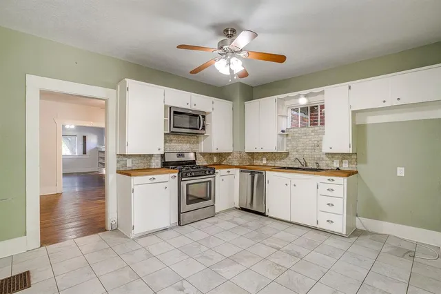a kitchen with a stove a sink and a refrigerator