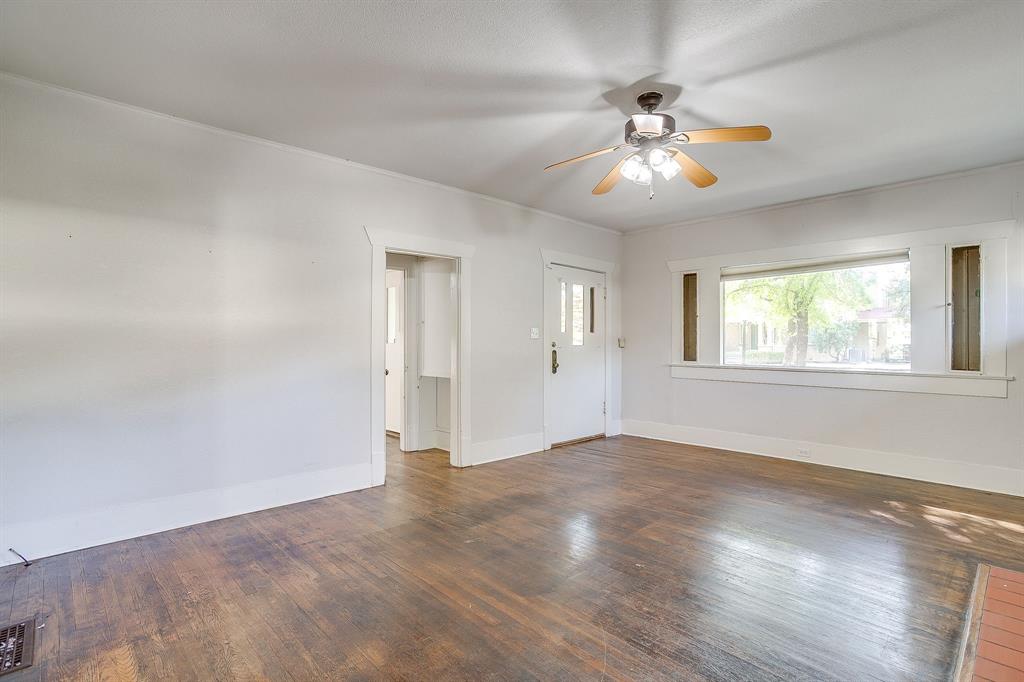 2312 Mistletoe Avenue Fort Worth, TX 76110 - Photo 6 of 40 wooden floor in an empty room with a window