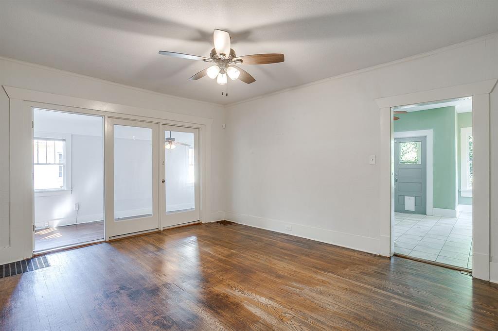 2312 Mistletoe Avenue Fort Worth, TX 76110 - Photo 10 of 40 a view of an empty room with wooden floor and a window
