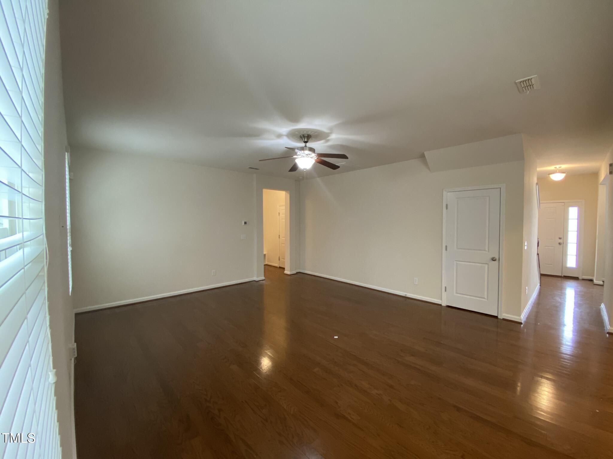 3545 Massey Ridge Court Raleigh, NC 27616 - Photo 11 of 38 an empty room with wooden floor fan and windows