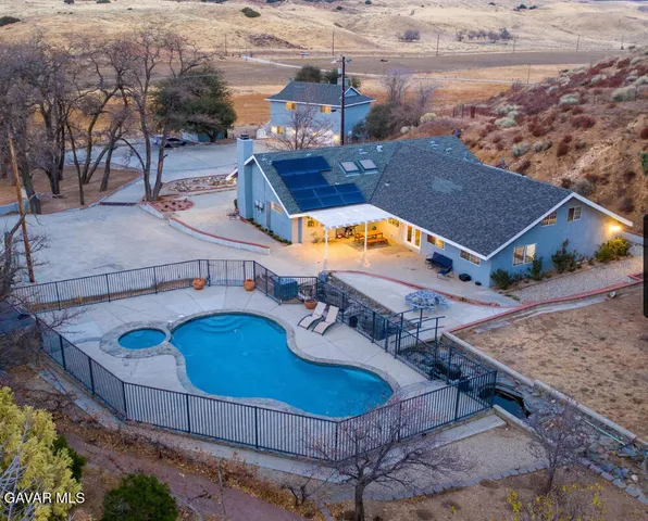 an aerial view of a house with swimming pool
