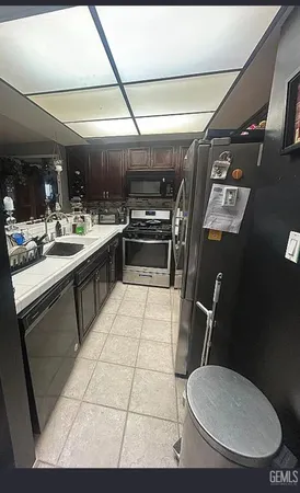 a kitchen with a sink a toilet and a mirror