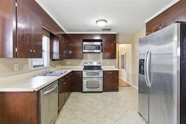 a kitchen with a sink stove and refrigerator