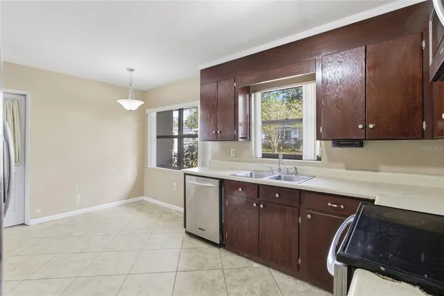 a kitchen with a sink window and cabinets