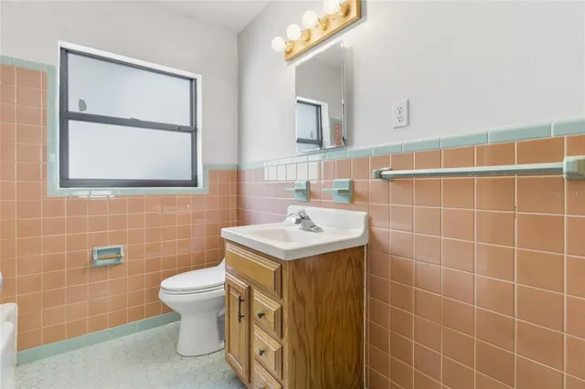 a bathroom with a sink toilet and mirror