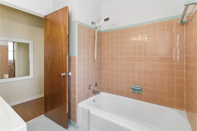 a bathroom with a bathtub and a shower