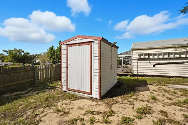 a view of a pathway of a house with wooden fence