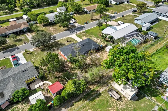 an aerial view of residential house with outdoor space and swimming pool