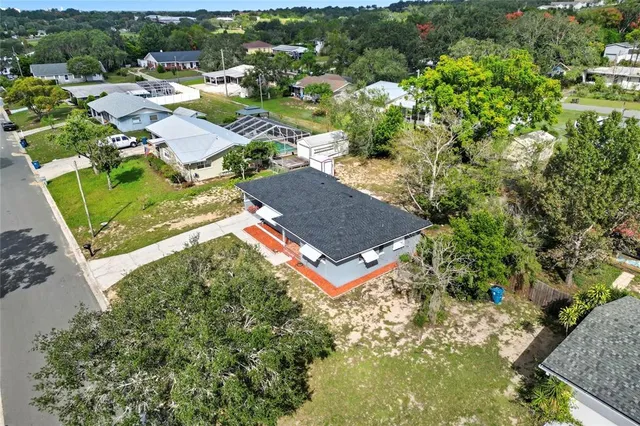 an aerial view of a house with a yard