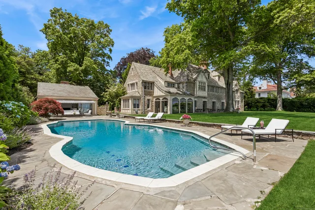 a view of a swimming pool and lounge chairs