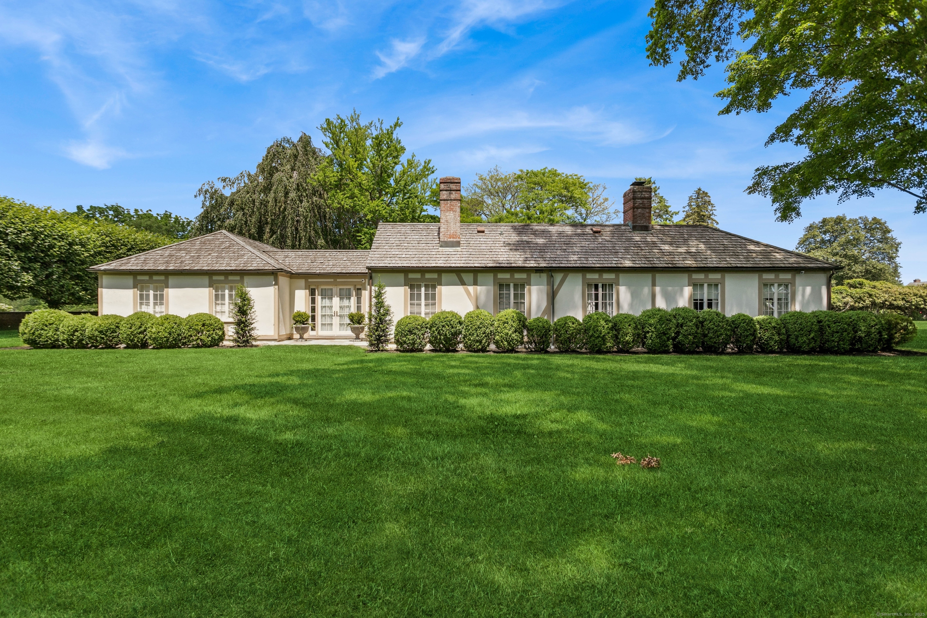92 Beachside Avenue Westport, CT 06880 - Photo 21 of 28 a front view of a house with a yard