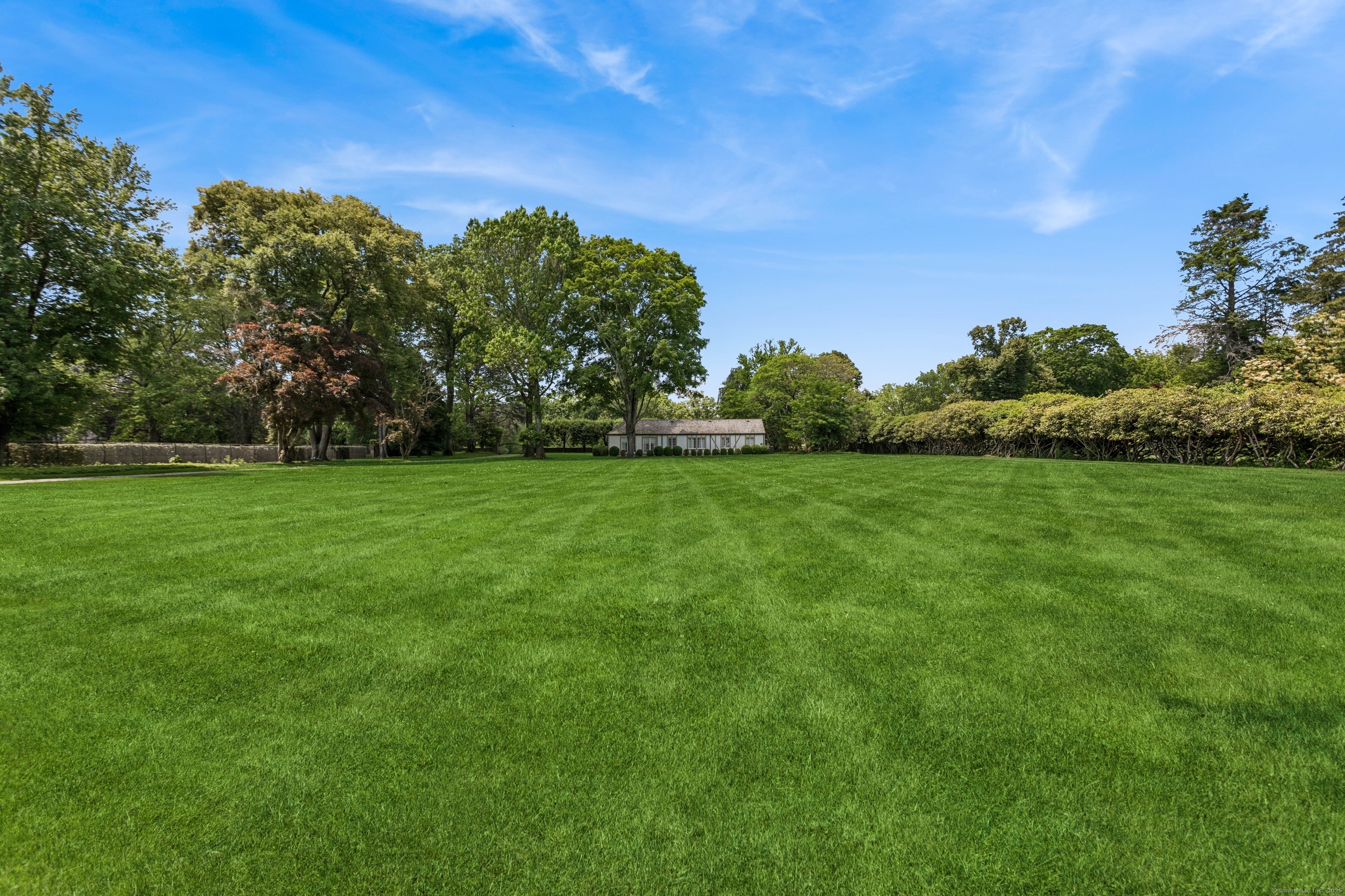 92 Beachside Avenue Westport, CT 06880 - Photo 25 of 28 a view of a grassy field with trees in the background