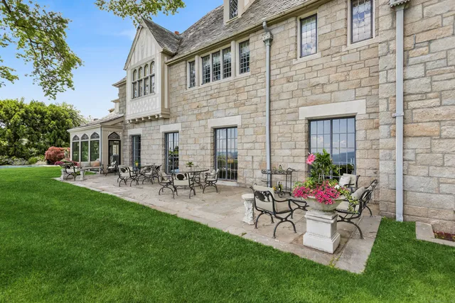a view of house and patio with a garden