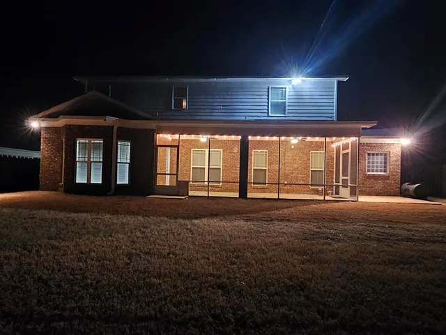 a spacious bedroom with a large bed and large windows