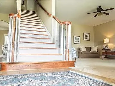 a view of a livingroom with furniture and staircase