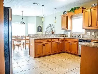 a kitchen with a sink stove and cabinets