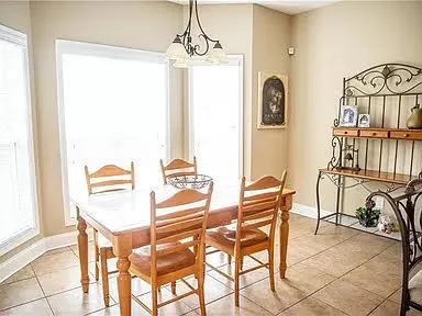 a view of a dining room with furniture and a chandelier