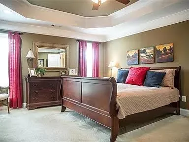 a bedroom with a bed and a chandelier