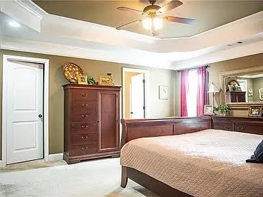 a bedroom with a bed and a chandelier