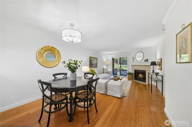 a view of a dining room with furniture a chandelier and wooden floor